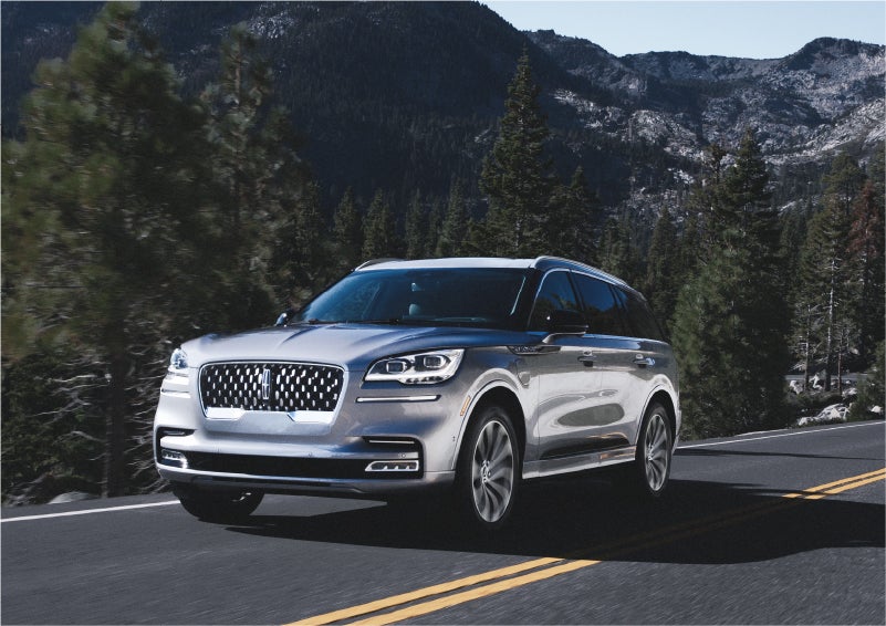 A 2023 Lincoln Aviator® Grand Touring SUV being driven on a winding road to demonstrate the capabilities of all-wheel drive | Star Lincoln in Southfield MI