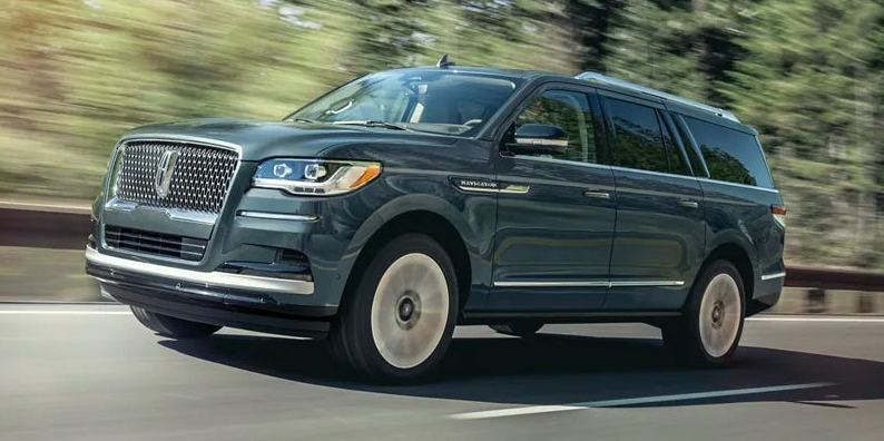 A blue 2023 Lincoln Navigator in drive.