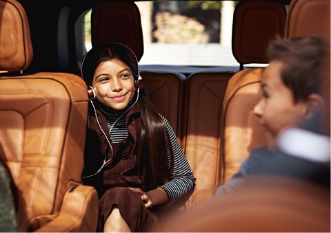 Two young people are comfortably seated in the second and third rows of a Lincoln Aviator® SUV | Star Lincoln in Southfield MI