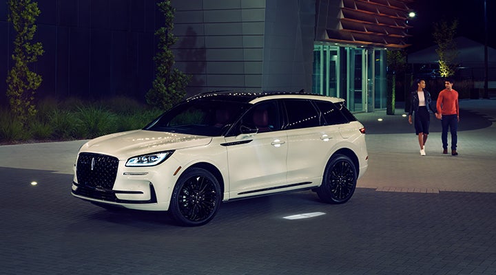 Two people approach a 2024 Lincoln Corsair® SUV featuring the available Jet Appearance Package. | Star Lincoln in Southfield MI