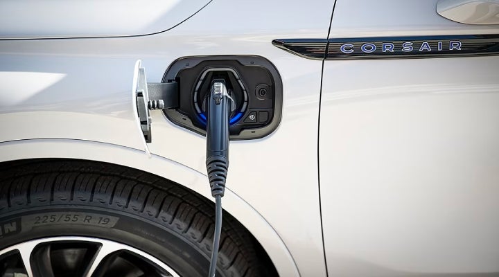 An electric charger is shown plugged into the charging port of a Lincoln Corsair® Grand Touring
model. | Star Lincoln in Southfield MI