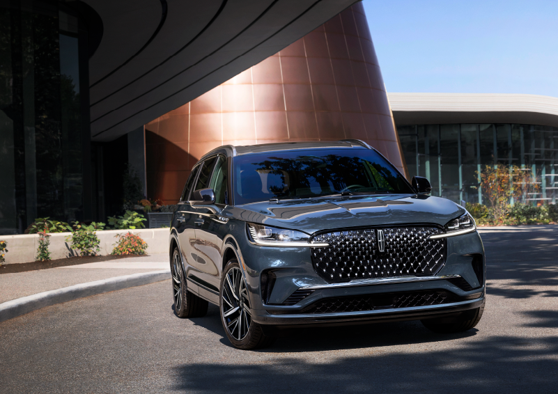 A gray 2025 Lincoln Aviator® SUV is parked outside a modern building with the sun shining. | Star Lincoln in Southfield MI