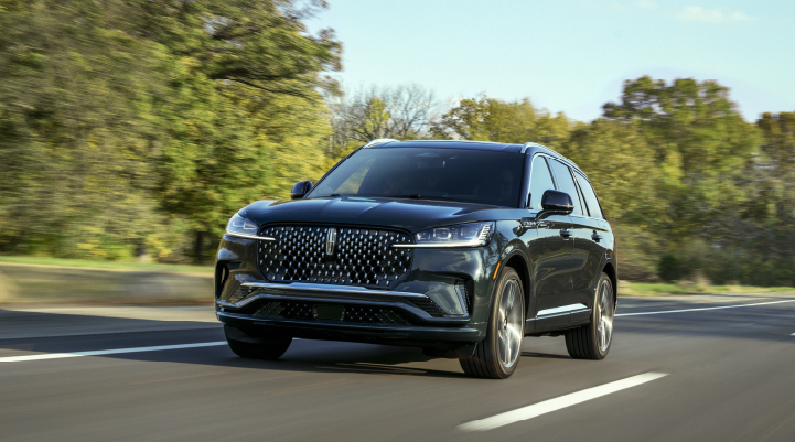 A 2025 Lincoln Black Label Aviator® SUV is being driven down a road lined with trees. | Star Lincoln in Southfield MI