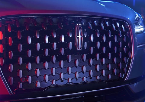 The grille of a 2025 Lincoln Corsair® SUV reflects neon light at night. | Star Lincoln in Southfield MI