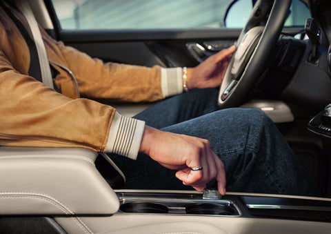 The driver of a 2024 Lincoln Corsair® SUV is shown selecting the drive mode. | Star Lincoln in Southfield MI