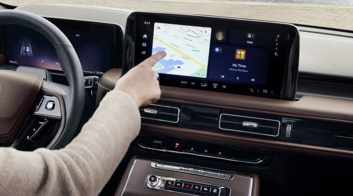 A person is tapping the center display touchscreen of a 2026 Lincoln Aviator® SUV. | Star Lincoln in Southfield MI