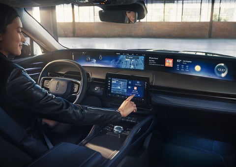 The driver of a 2026 Lincoln Nautilus® SUV interacts with the center touchscreen. | Star Lincoln in Southfield MI