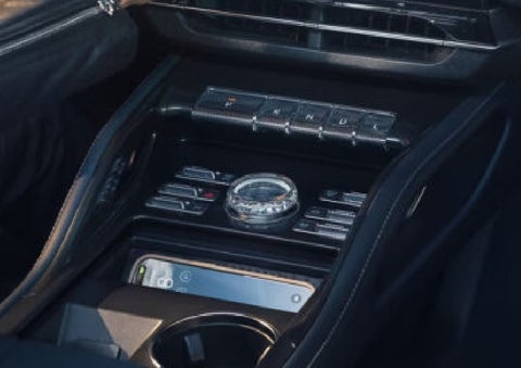 A smartphone is shown charging in the wireless charging pad. | Star Lincoln in Southfield MI