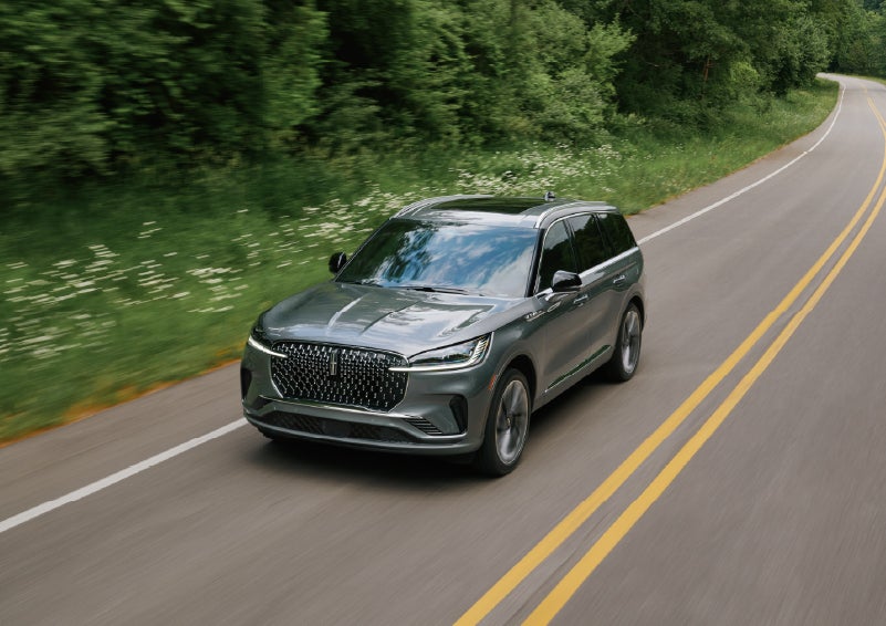 A 2027 Lincoln Aviator® SUV is being driven down a road. | Star Lincoln in Southfield MI