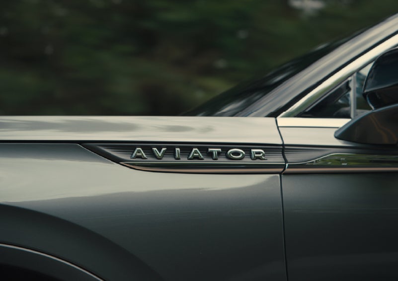 The driver’s side door and fender badging of a gray 2027 Lincoln Aviator® SUV are showcased. | Star Lincoln in Southfield MI