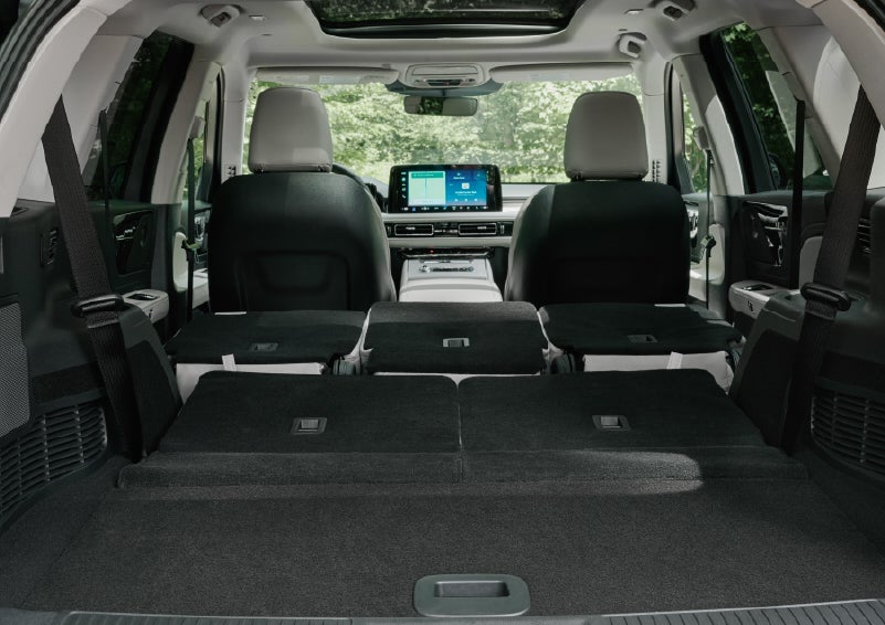 A rear to front view of the interior of a 2027 Lincoln Aviator® Black Label™ SUV shows the third and second rows folded flat | Star Lincoln in Southfield MI