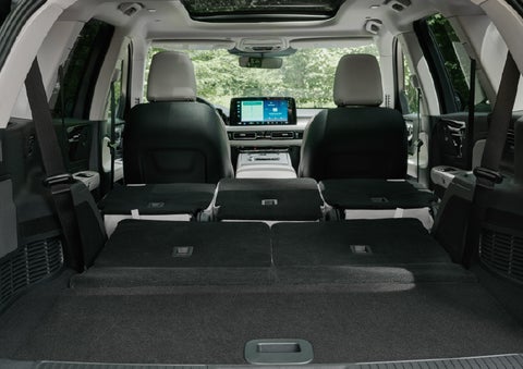 A rear to front view of the interior of a 2027 Lincoln Aviator® Black Label™ SUV shows the third and second rows folded flat | Star Lincoln in Southfield MI