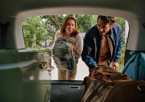 A couple loads luggage into the rear of a 2027 Lincoln Aviator® Black Label™ SUV..e 202 | Star Lincoln in Southfield MI