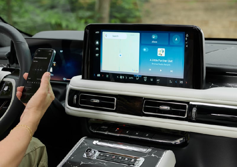 A person pairs thier phone with the center touchscreen of a 2027 Lincoln Aviator® Black Label™ SUV | Star Lincoln in Southfield MI